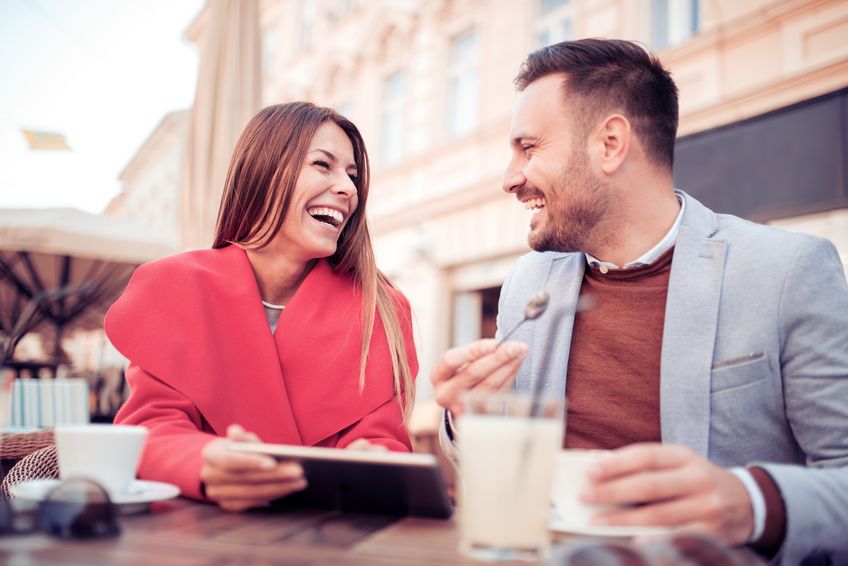 Fun couple drinking chatting while drinking coffee