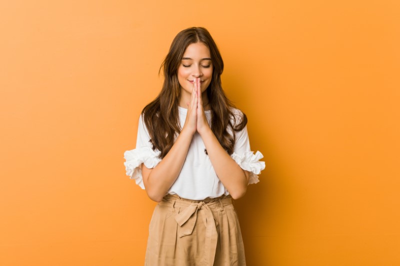 Long-haired christian woman praying