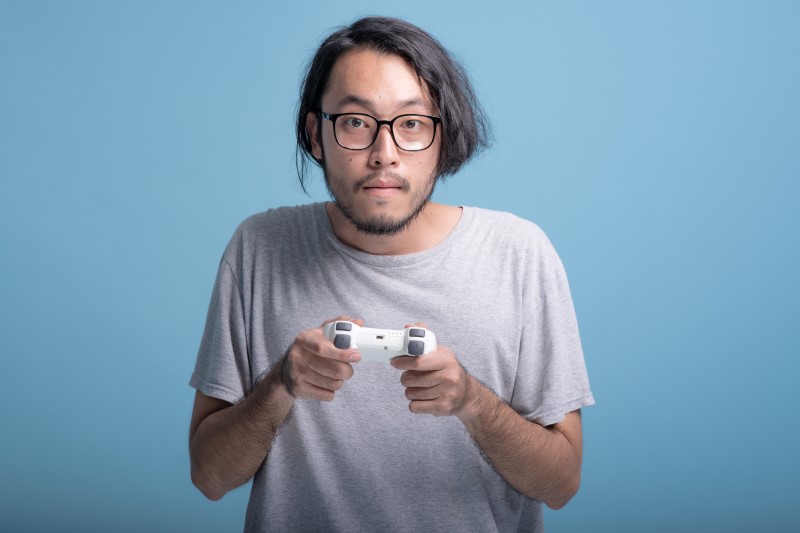 Stereotypical asian man who plays console games