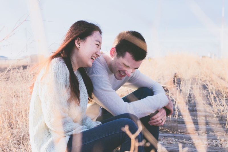 Laughing christian couple sitting