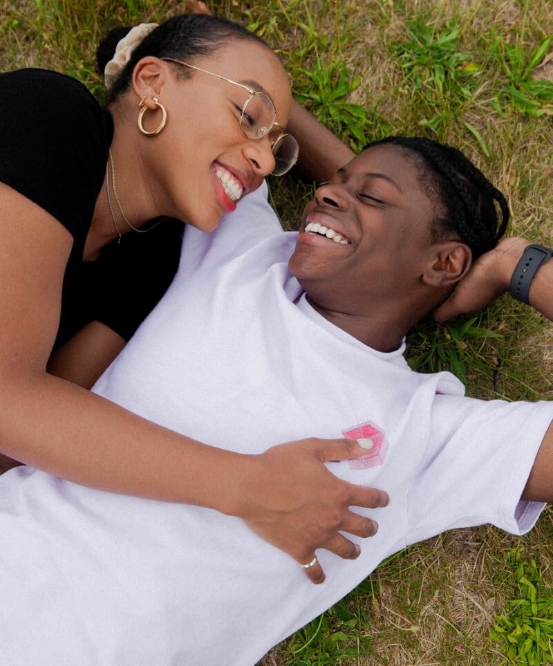 Lesbian girlfriends lying on grass