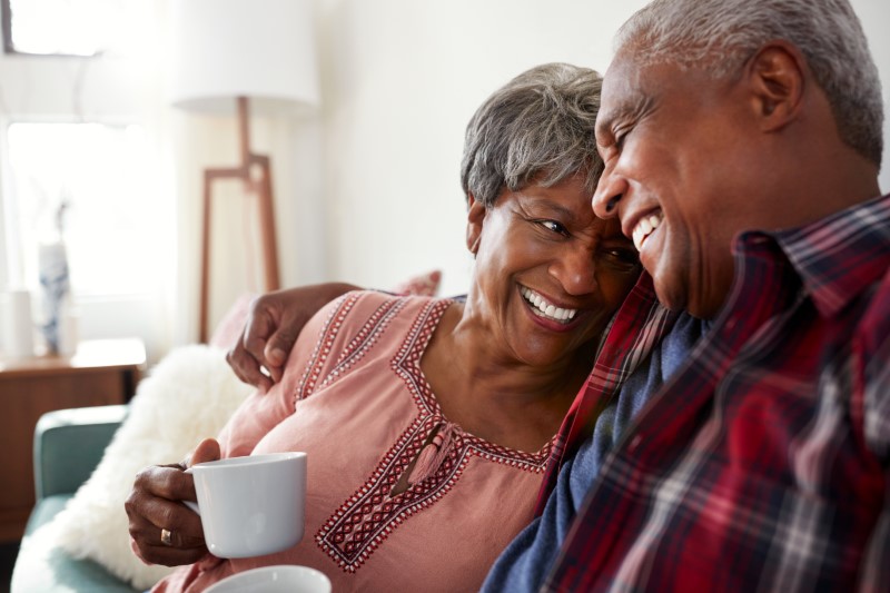 Senior couple laughing together at home