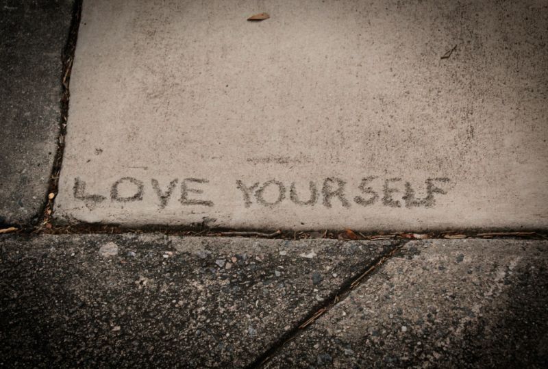 Love yourself put into a sidewalk